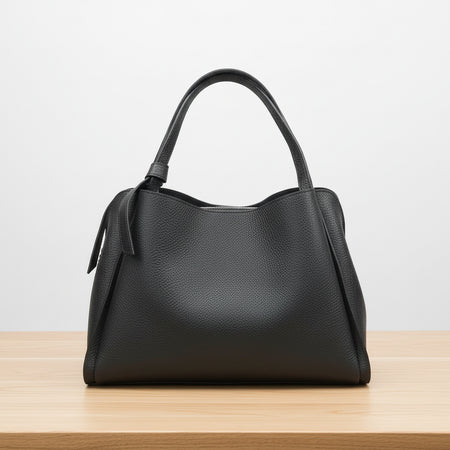 Black handbag on a white background